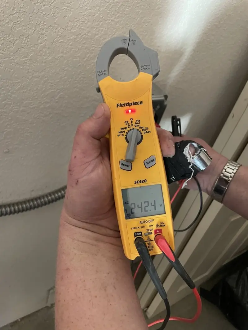 Voltage testing with clamp meter during Whole House Surge Protector in Menomonee Falls